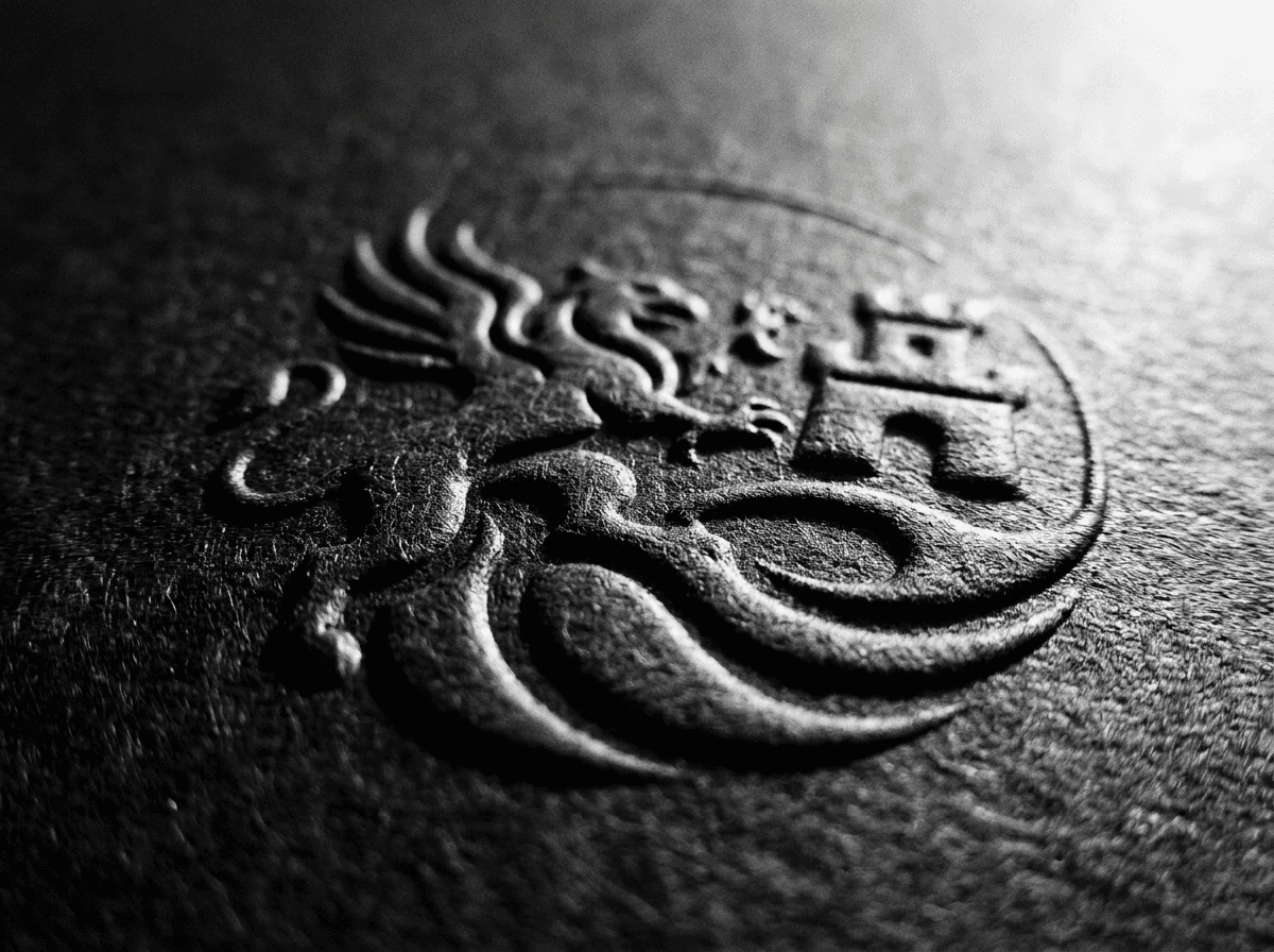 Embossed compliance seal in black